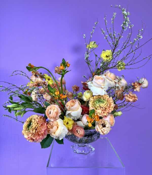 Flower arrangement with peach, yellow and white flowers