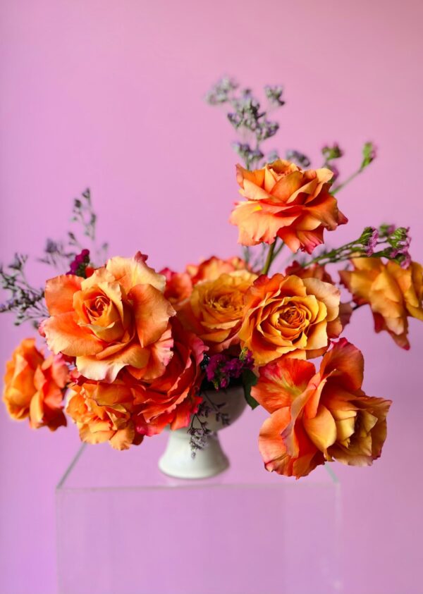 Flower arrangement with orange roses
