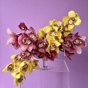 Flower arrangement with yellow and purple orchids