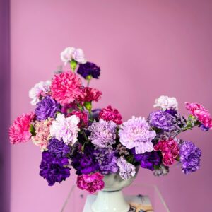 Flower arrangement with purple and pink carnations