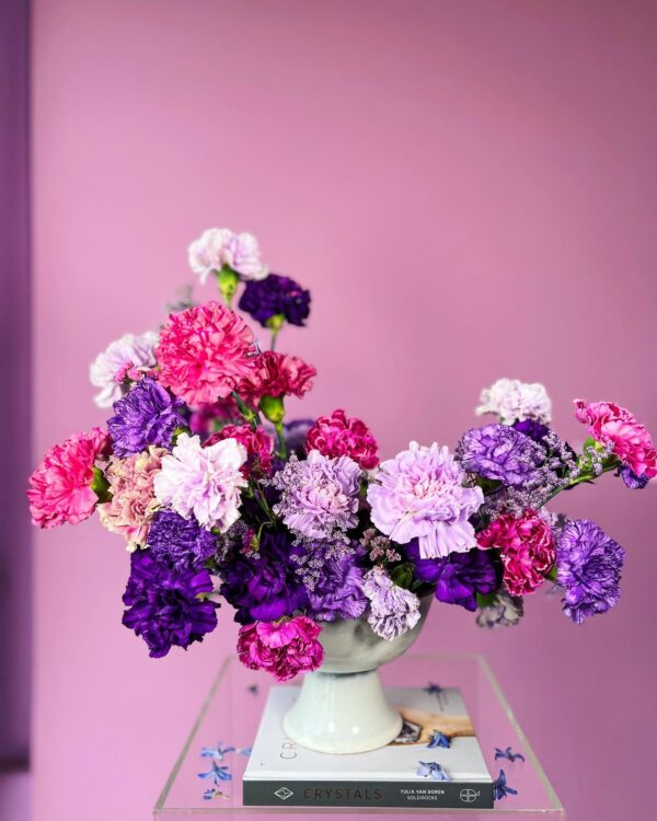 Flower arrangement with purple and pink carnations