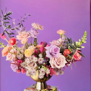 Flower arrangement with purple and pink roses