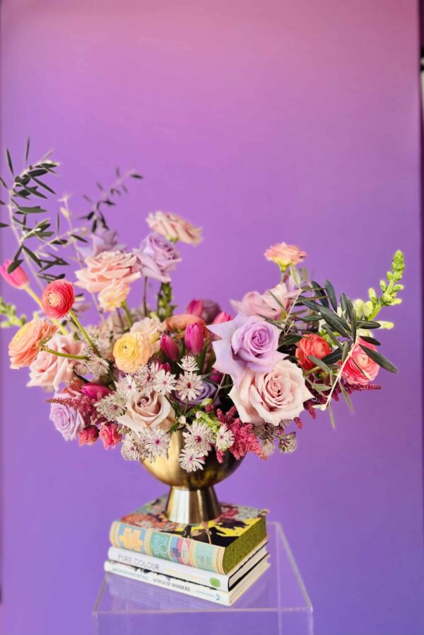 Flower arrangement with purple and pink roses