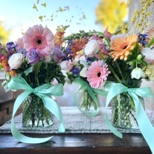Flower arrangement with carnations in decorative jars