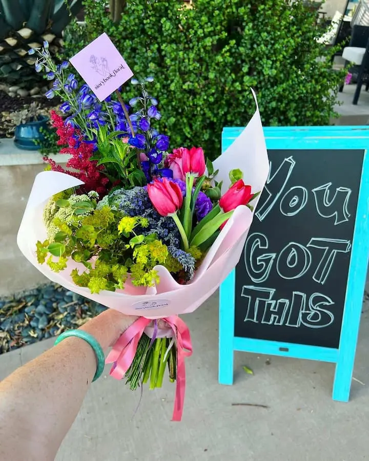 Flower bouquet with sign saying "you got this" in back